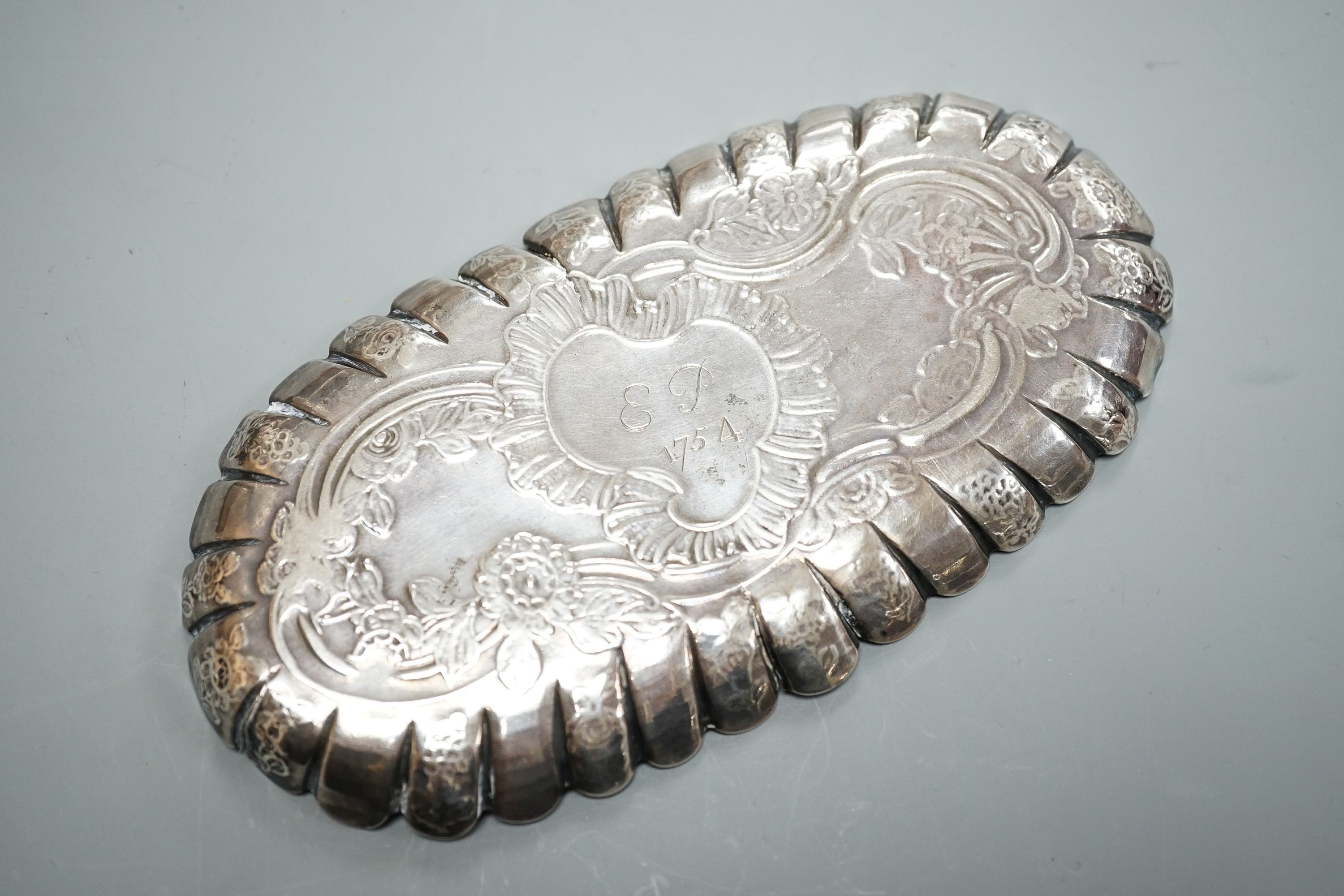 A mid 18th century Irish embossed silver oval pin tray, with engraved date and initials, maker ID?, Dublin, circa 1750, 16.4cm, 74 grams (a.f.)